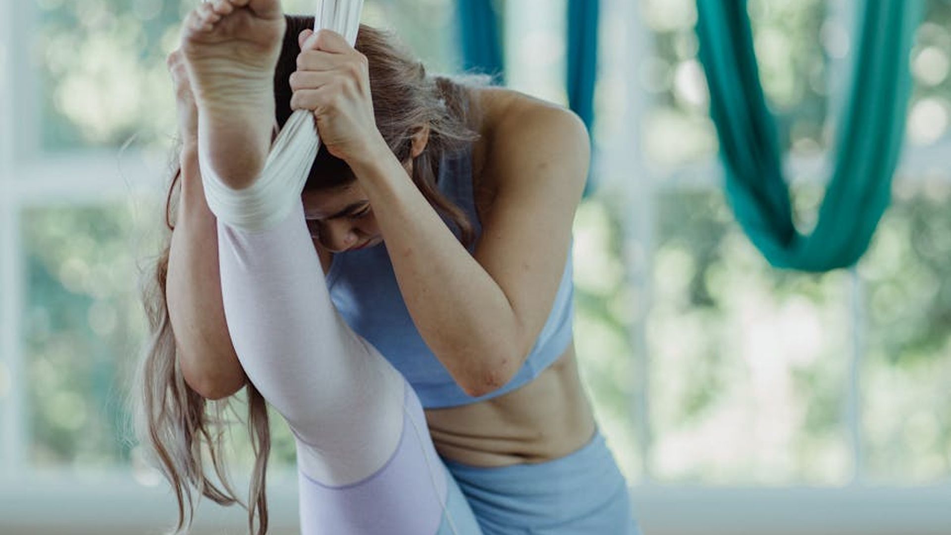 Woman practicing mindful movements in a bright airy studio room